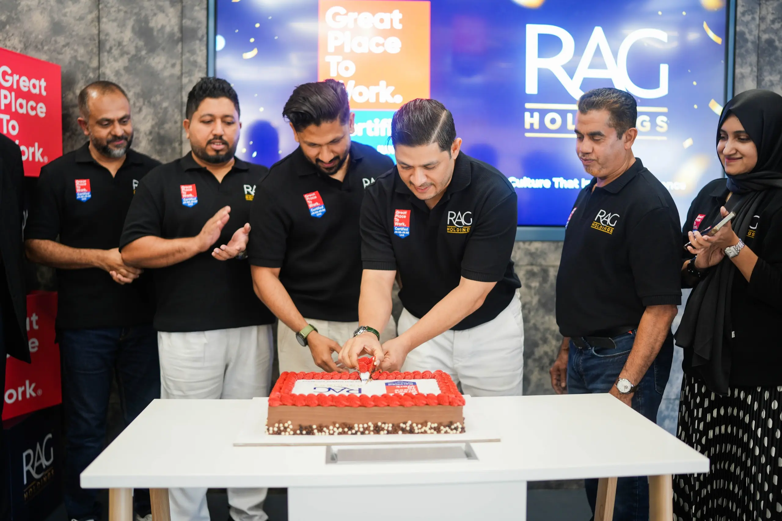 RAG Holdings employees working together in a collaborative and supportive environment.