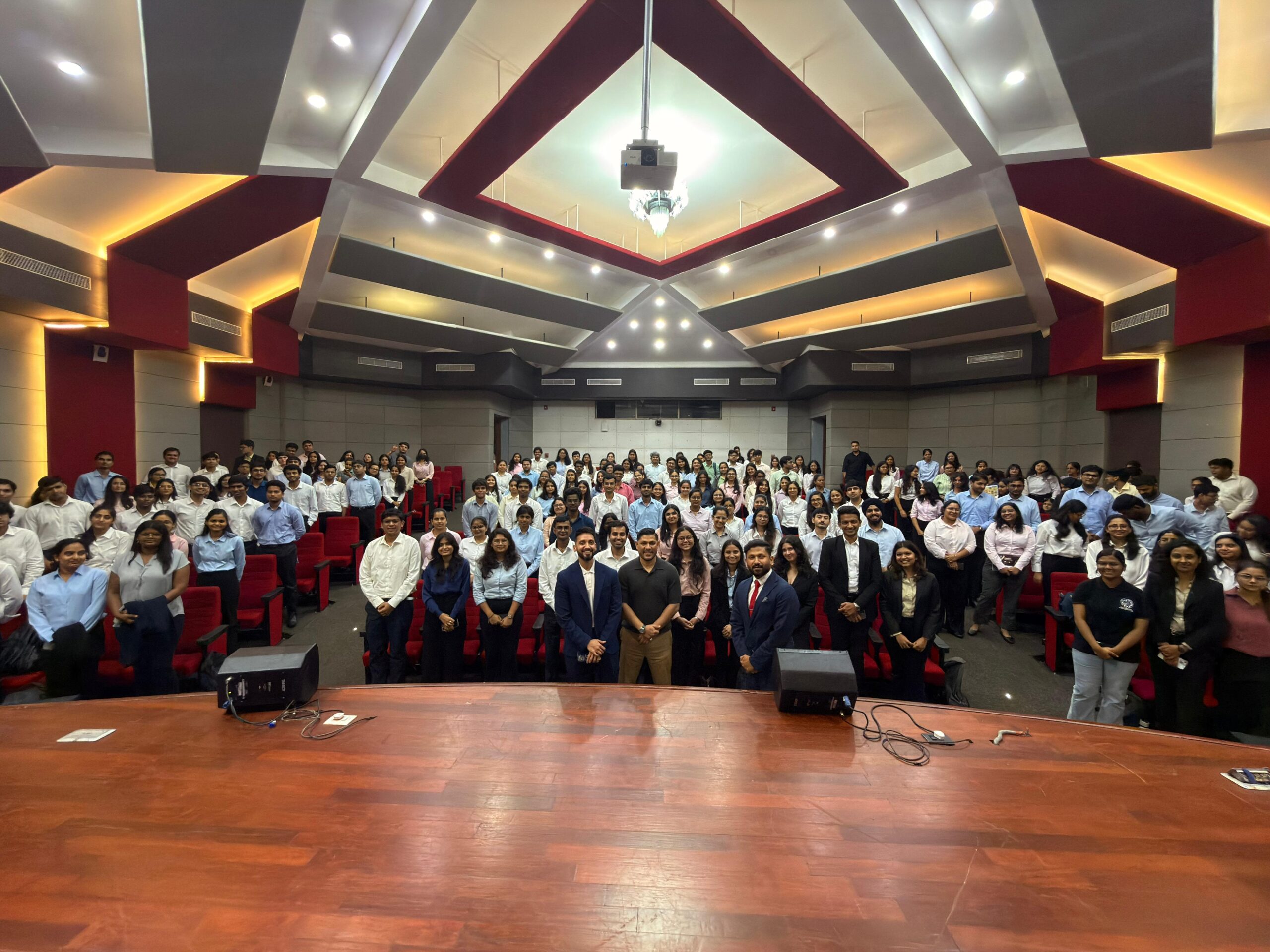 RAG leadership team posing for a group photograph with students in the auditorium at IIM Kozhikode